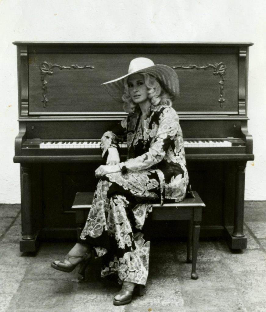 Tammy Wynette seated at piano