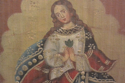 The Virgin Mary holding coca leaves